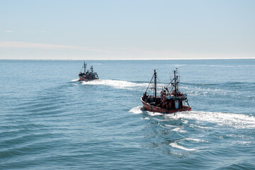 Two small Trawler fishing vessels, sailing in the Atlantic Ocean