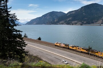 Majestic Columbia River Scenic Overlook: 4K Image with Cargo Train and Freeway Traffic in Oregon, USA