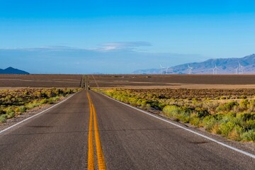 Fototapeta na wymiar Desert Highway Road and Wind Turbines: Scenic Wheat Field Landscape in 4K