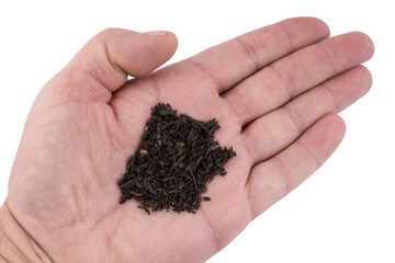 some dry tea leaves on the palm of your hand