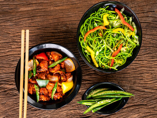 Asian food on wooden background with chop sticks