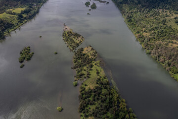 Bird's eye view of an empty beach with green landscape