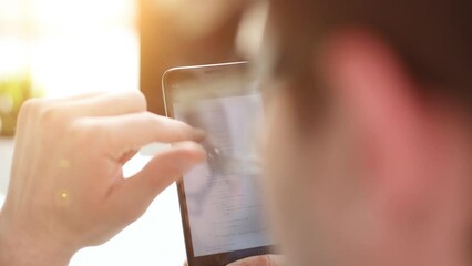 businessman with a phone reading emails, text messages or checking news online on social media app.