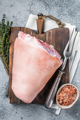 Uncooked Raw pork ham hocks, shanks on a wooden board with spices. Gray background. Top view