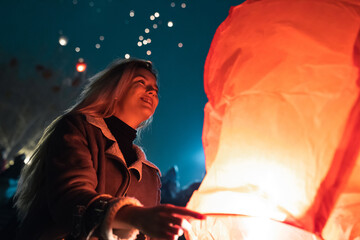 Female lighting up sky lantern