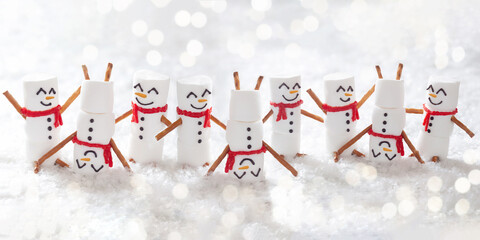 Happy funny marshmallow snowman are having fun in snow. Merry Christmas banner.