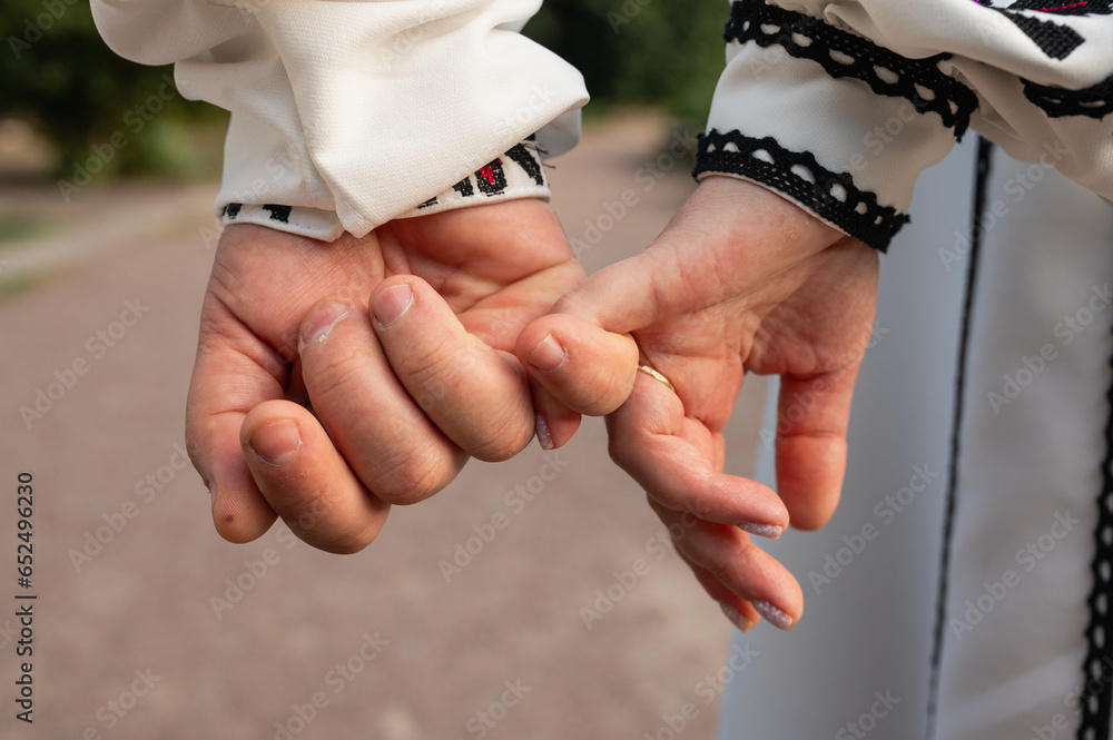 Canvas Prints close-up view of a young couple holding hands in embroidered traditional Ukrainian clothes