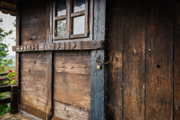 Fototapeta na wymiar Wooden Front Door into rustic cabin with lock and padlock and chain,