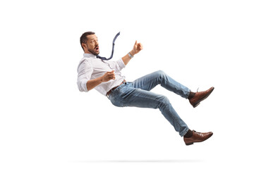 Scared young businessman falling