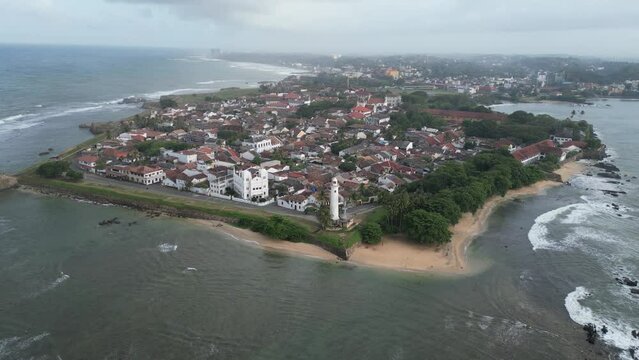 cinematic aerial close up drone footage of the famous Galle Fort, an ancient fortress and iconic landmark situated by the Indian Ocean in Galle, Sri Lanka, South Asia - no edits - no color correction