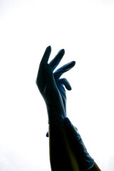 Hands in gloves, black silhouettes on a white background. Medicine. Sterilization. High quality photo