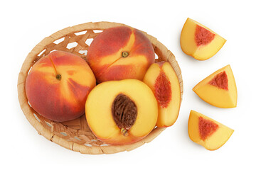 Ripe peach fruit with half in a wicker basket isolated on white background with full depth of field. Top view. Flat lay