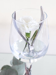 Scissors for manicure in a glass of water and a white flower. Beauty salon, aesthetics, sterilization. High quality photo