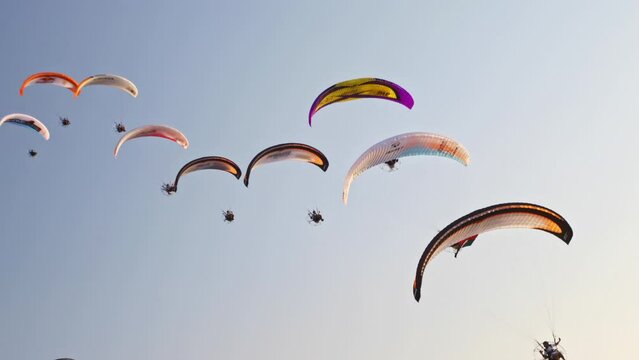Low shot of paragliders flying overhead near Dubai