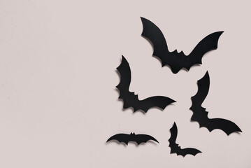 Paper bats for Halloween party on grey background