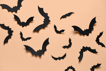 Paper bats for Halloween party on orange background