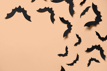 Paper bats for Halloween party on orange background