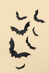 Paper bats for Halloween party on yellow background