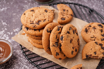 Grid of tasty cookies with chocolate chips on grey background