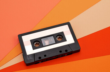 retro tape recorder cassette on a colorful orange background