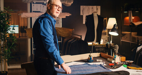 Experienced tailor designing fabric to mnaufacture custom made clothing items, craftsmanship...