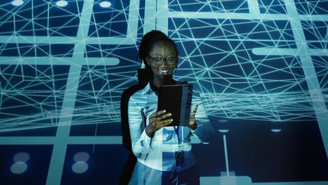 Computer scientist programming in AI server farm housing advanced equipment used for machine learning training. Developer running code on tablet to upgrade artificial intelligence rigs