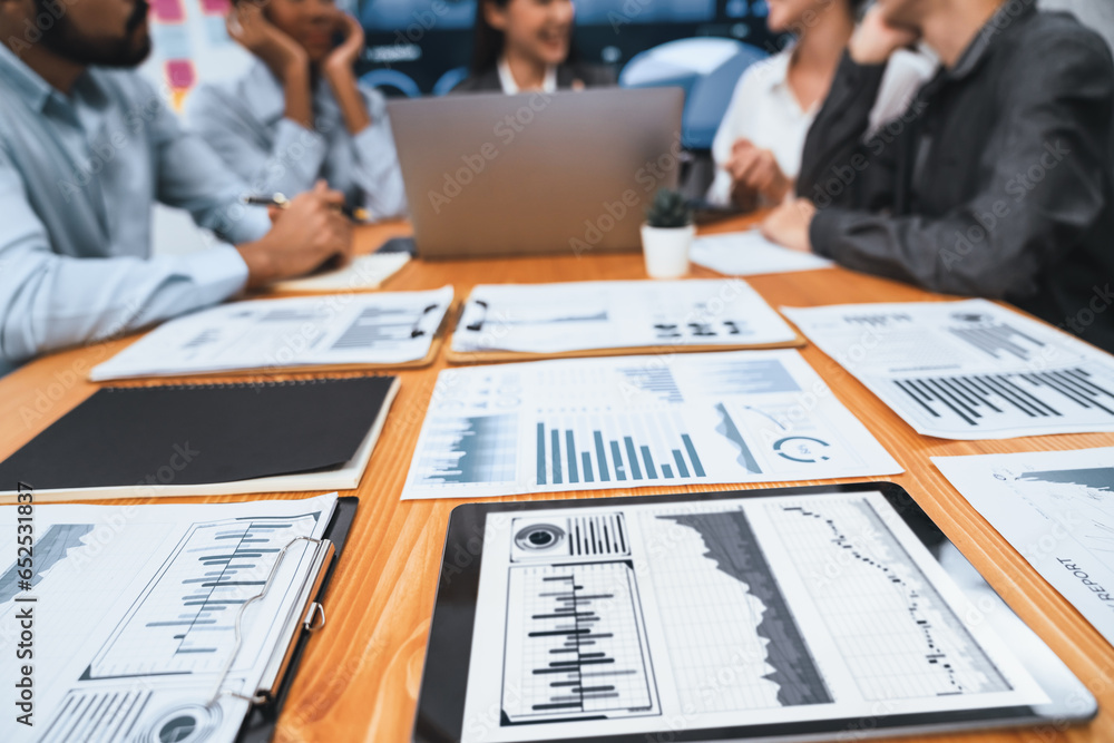 Poster focus financial dashboard paper showing graphs and chart with blurred background of diverse business