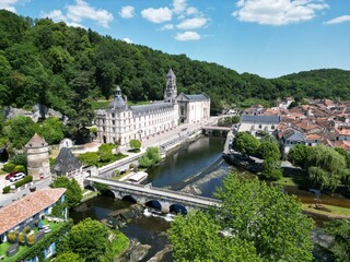 Brantome  abbey and stone bridge France in Dordogne medieval town drone,aerial - obrazy, fototapety, plakaty