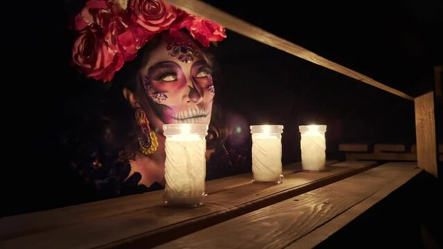 Embracing Mexican Traditions: Catrina's Vibrant Day of the Dead Costume Illuminated by Candlelight