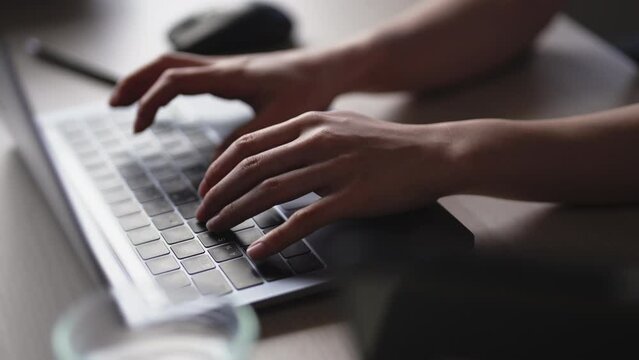 Closeup hands typing keyboard on laptop searching information, online working, distance job at home.