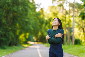 Happy young Asian woman relaxing outdoors, Enjoy beauty of nature and find inner peace on a sunny afternoon, relax time, love your self.