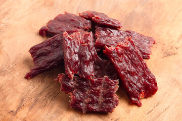 Fototapeta premium Pile of Kippered Beef Steak Beef Jerky on a Rustic Wooden Table