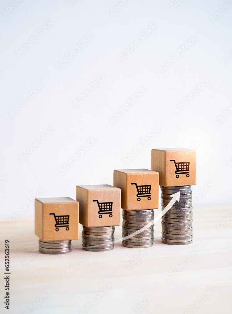Poster shopping cart icon on wood cube blocks on coin stacks as a growth graph steps with rise arrow on whi