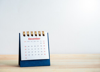 December page on 2023 desk calendar for the organizer and schedule plan isolated on wood table on...