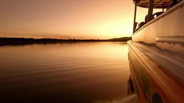 Fast boat along Ord River Western Australia during sunset