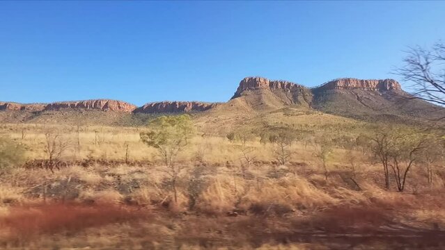 DRiving south to north along Western Australian highway passing boab trees and red earth