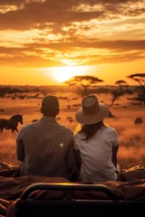 Foto op Canvas couple sitting on the floor Grass and a jeep in the grass field with wild animals in the background, the sunset © ND STOCK
