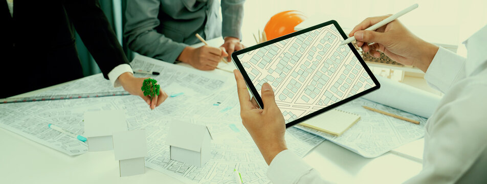 Worker, architect and engineer work on real estate construction project oratory planning with cartography and cadastral map of urban town area to guide to construction developer business plan of city