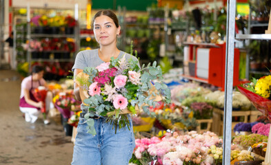 Female shopper chooses a chic bouquet of flowers at the flower market