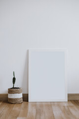 Blank white canvas mock-up on white wall. Modern style interior with poster artwork template. Blank empty copy space frame mockup.