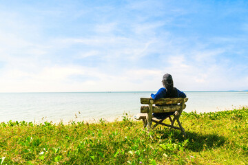 Beautiful woman with long hair sitting at the beach Relax in nat