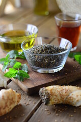 Middle eastern, Arabic traditional breakfast with Zaatar Olive oil, a cup of tea, and sesame bread 