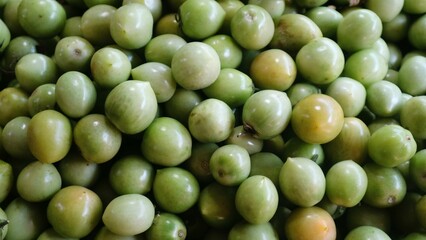 Pile of raw natural green tomatoes, natural background