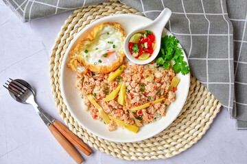 Stri fried pre boiled bamboo shoot and minced pork with fried egg and thai style sauce , top view food table