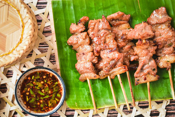 grilled pork thai style on banana leaf, top view, thai call Moo ping