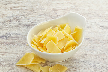 Sliced parmesan cheese heap in the bowl