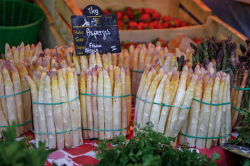 Fresh locally grown white asparagus for sale at a farmers market on Place Broglie Square in the...