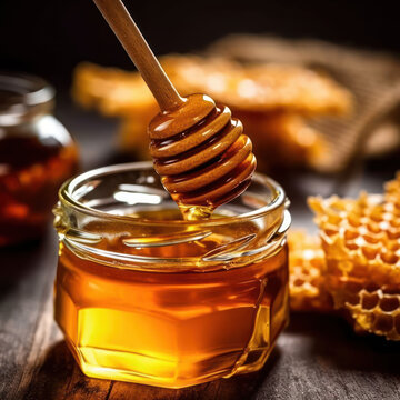  A jar of honey with a wooden spoon and a honeycomb
