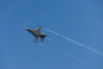 Fighter jet flying in the blue clear sky demonstrating skills_3