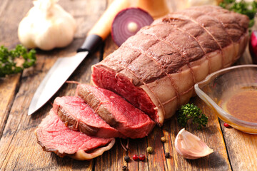 roast beef sliced on wood background